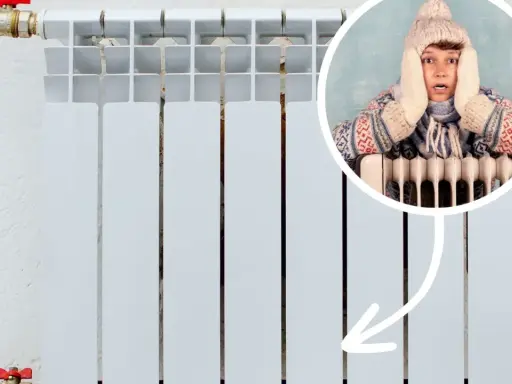 Chłopak w czapce i szaliku trzyma się za głowę, bo zimne grzejniki na dole nie grzeją.
