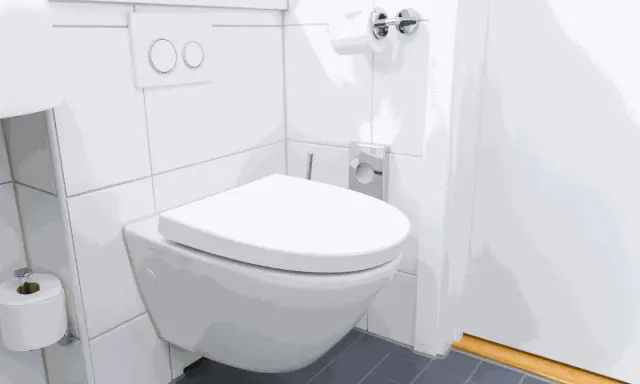 Nowoczesna, wisząca miska WC wydaje się być zamontowana za nisko, co może utrudniać korzystanie. Obok rolka papieru toaletowego.